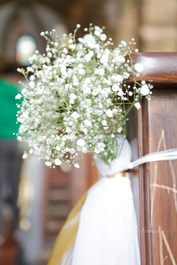 Beautiful delicate flowers tied in a sash around the seating area in St.Francis Xavier Church. 