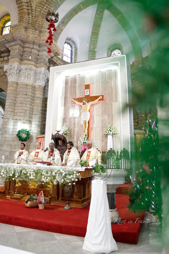The priests conducting the wedding mass with Christ on the cross behind. This is at a Church in Bengaluru.